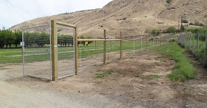 Game fence constructed with poles and wire